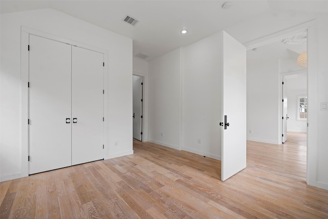 unfurnished bedroom featuring visible vents, recessed lighting, light wood-type flooring, and baseboards