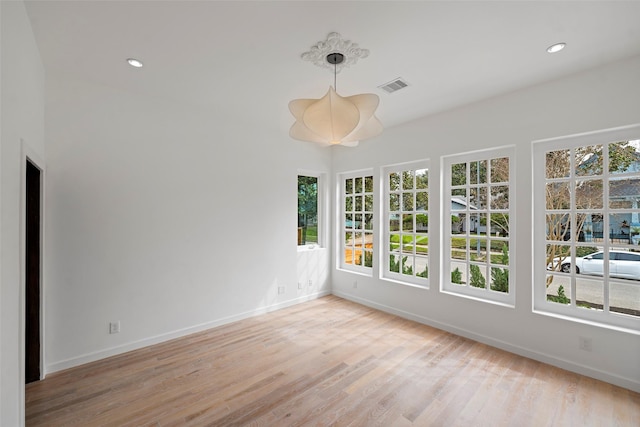 unfurnished sunroom featuring visible vents