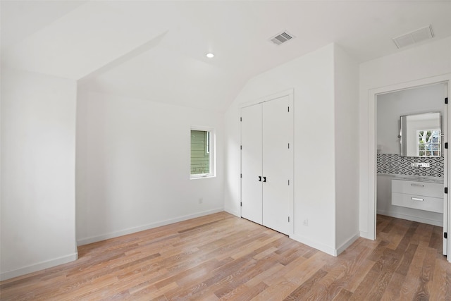 unfurnished bedroom with light wood-style flooring, baseboards, and visible vents