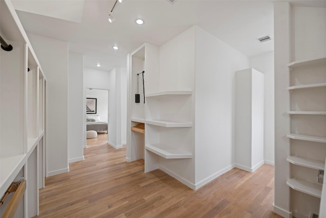 spacious closet with visible vents and light wood-style flooring