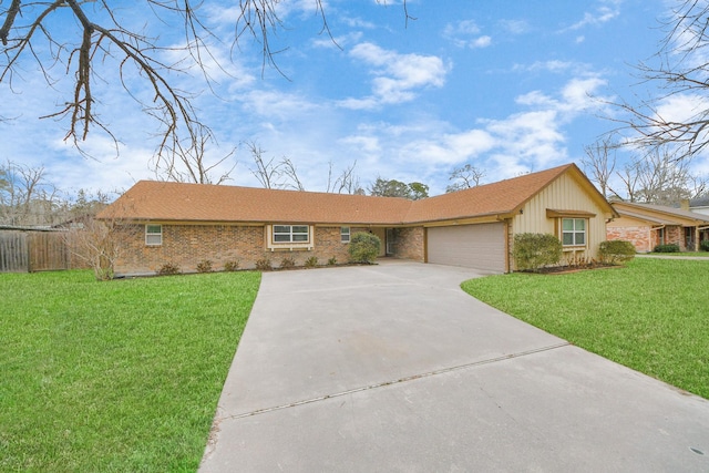 ranch-style house featuring a front yard, an attached garage, brick siding, and driveway