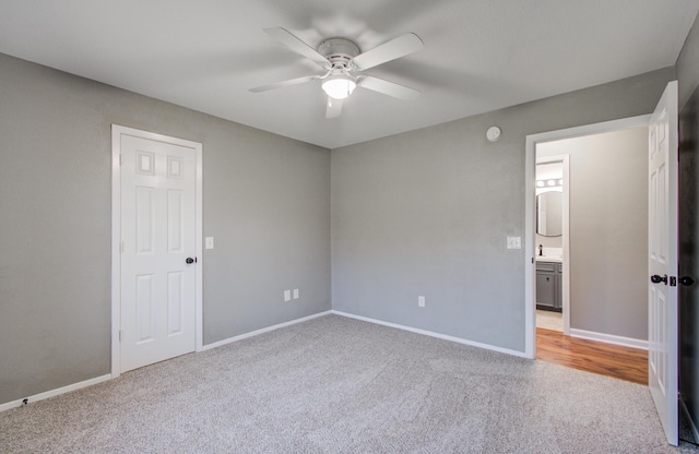 unfurnished bedroom featuring baseboards, light carpet, and ceiling fan