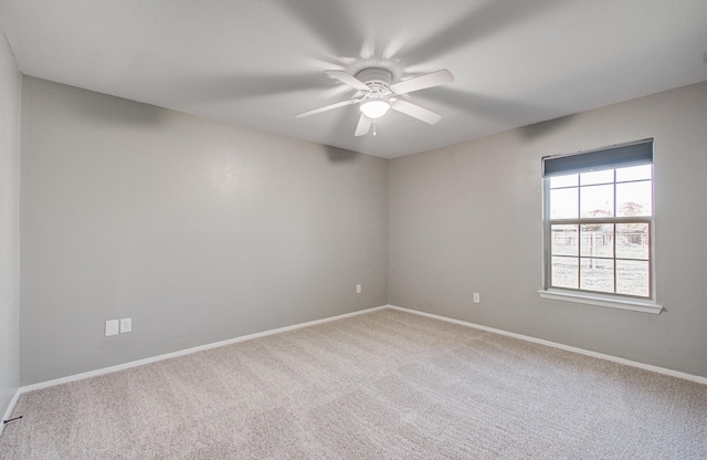 spare room featuring baseboards, ceiling fan, and carpet floors