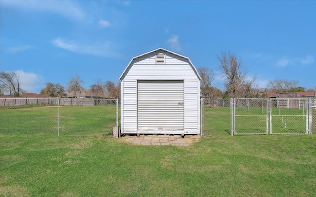 view of shed featuring a gate and a fenced backyard