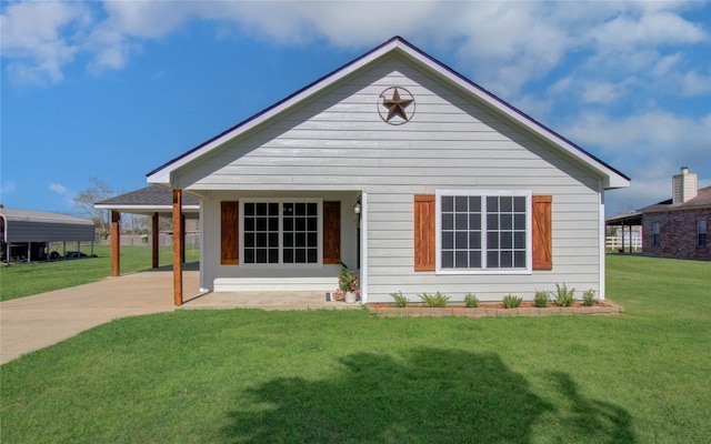 view of front of property with a front yard and a carport