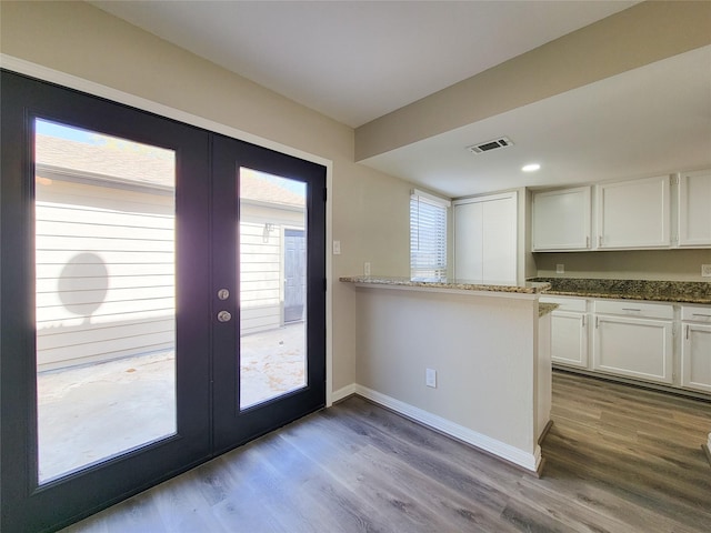 kitchen with visible vents, french doors, white cabinetry, and dark wood-type flooring