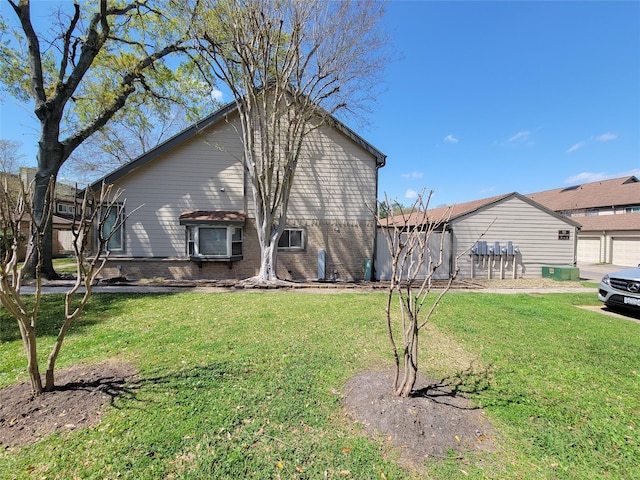 view of property exterior featuring brick siding and a yard