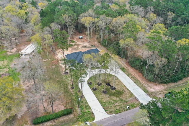 birds eye view of property with a view of trees