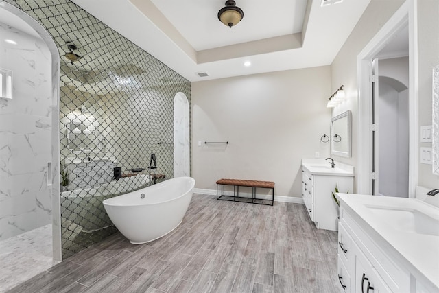 full bathroom featuring visible vents, wood tiled floor, two vanities, a sink, and a walk in shower