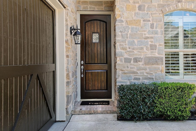 view of exterior entry with stone siding