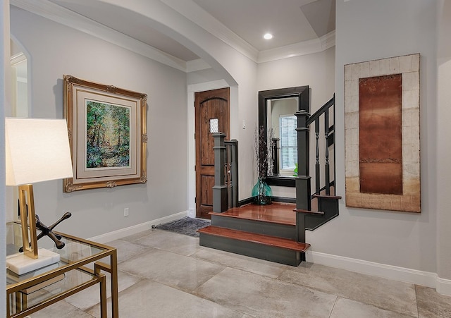 entrance foyer with baseboards, stairs, ornamental molding, recessed lighting, and arched walkways