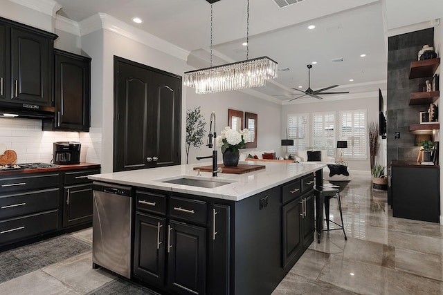 kitchen with an island with sink, ornamental molding, decorative backsplash, dark cabinetry, and stainless steel appliances