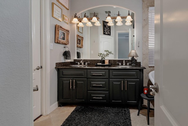 full bathroom with a sink, visible vents, double vanity, and tile patterned floors