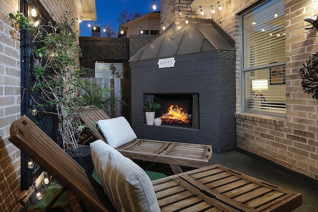 view of patio featuring an outdoor brick fireplace