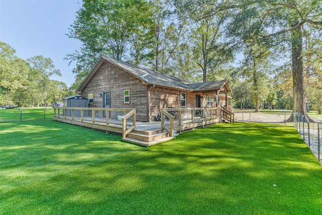 back of property with a lawn, a storage unit, and an outdoor structure