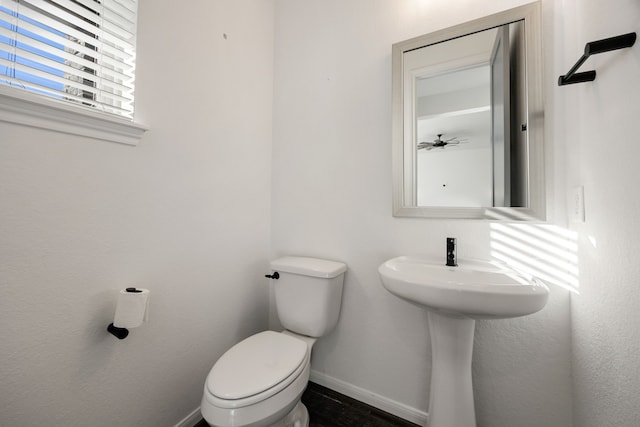 bathroom with baseboards and toilet