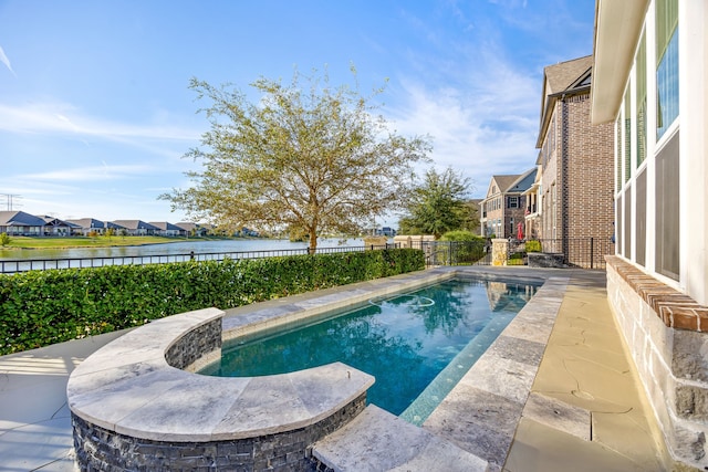 view of pool with a fenced in pool, a water view, a patio, and a fenced backyard