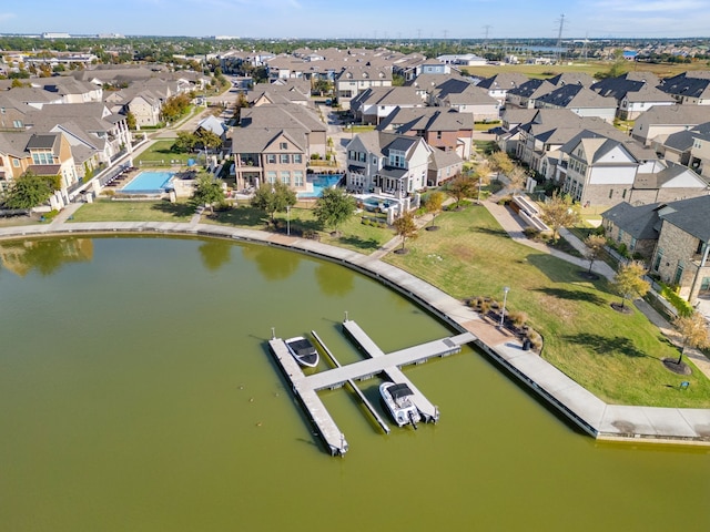 drone / aerial view with a residential view and a water view