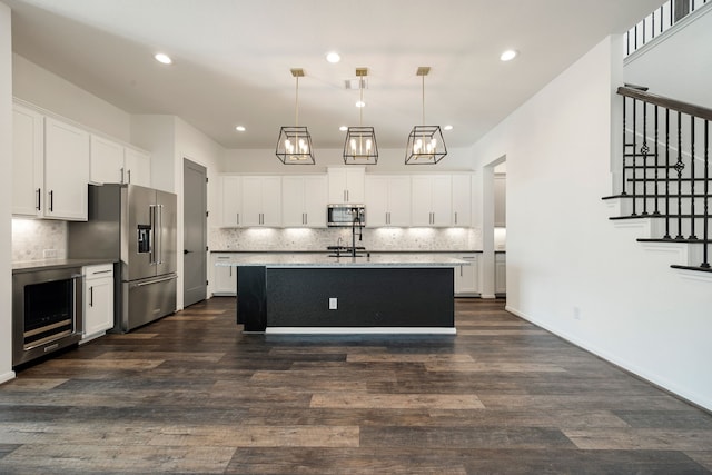 kitchen with a sink, stainless steel appliances, wine cooler, and dark wood finished floors