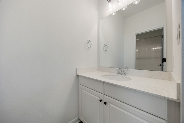 bathroom featuring baseboards and vanity