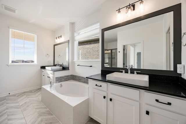 bathroom featuring visible vents, two vanities, a stall shower, a sink, and a bath