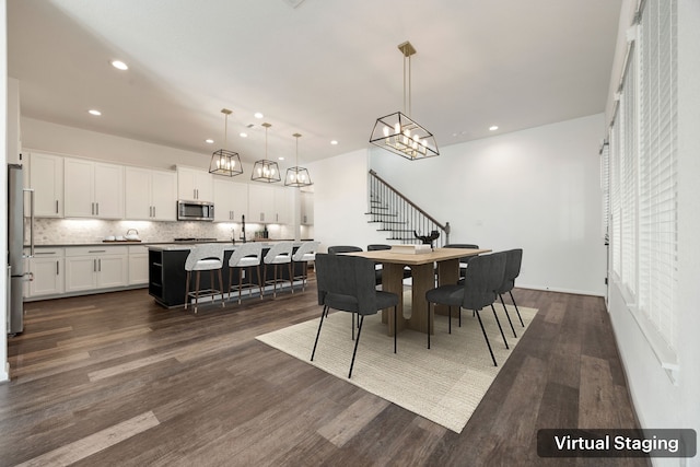 dining area featuring stairs, dark wood-type flooring, recessed lighting, and an inviting chandelier