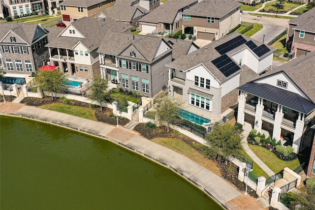 drone / aerial view with a residential view and a water view