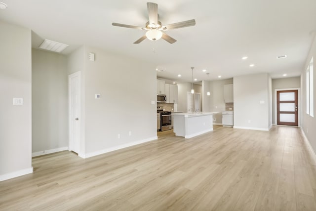 unfurnished living room featuring recessed lighting, baseboards, ceiling fan, and light wood finished floors