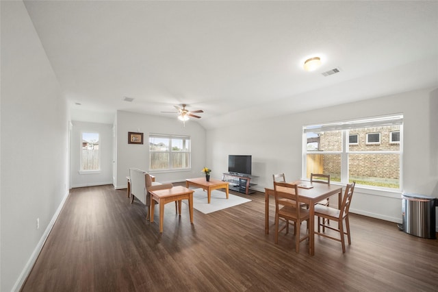 dining area with visible vents, baseboards, dark wood-style flooring, and vaulted ceiling