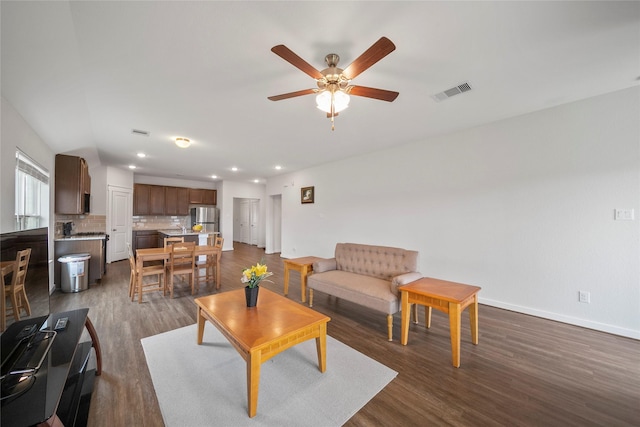 living area featuring visible vents, a ceiling fan, recessed lighting, baseboards, and dark wood-style flooring