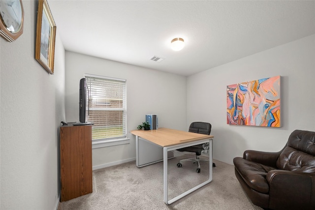 office space with carpet flooring, baseboards, and visible vents