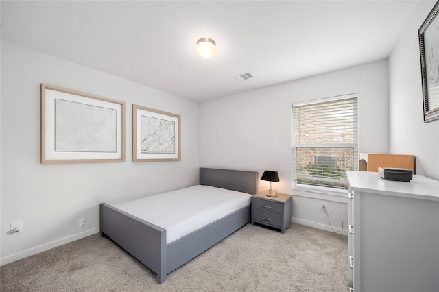 bedroom with visible vents, light colored carpet, and baseboards