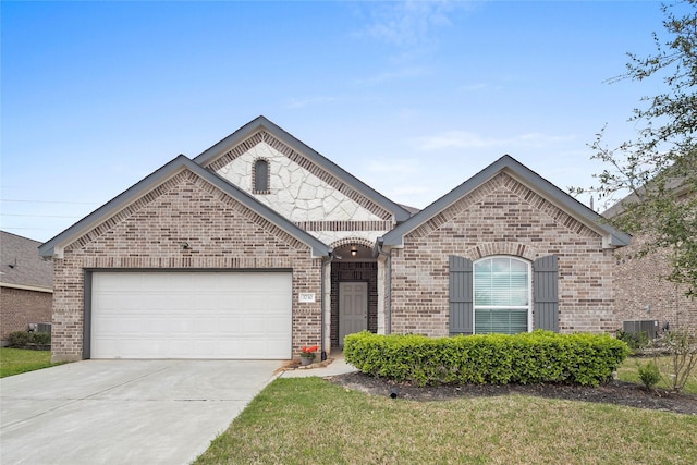 french country style house featuring brick siding, cooling unit, concrete driveway, and a garage