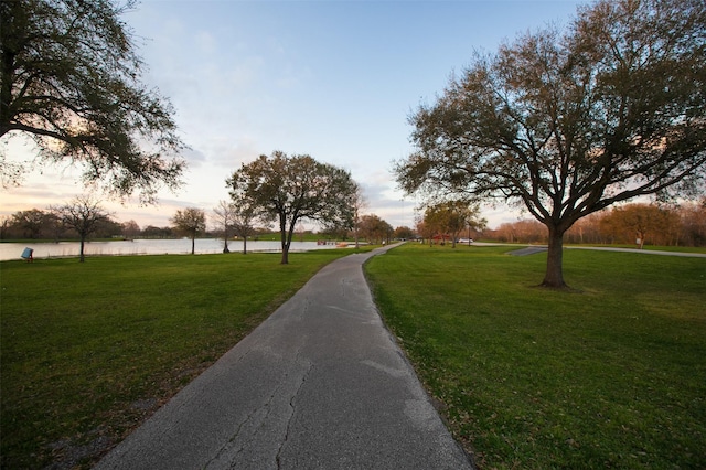 view of home's community with a yard and a water view