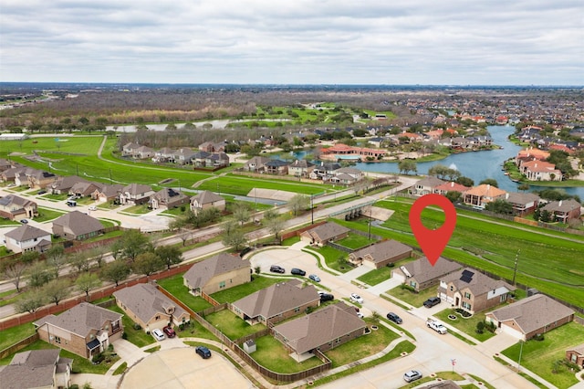 birds eye view of property with a residential view and a water view