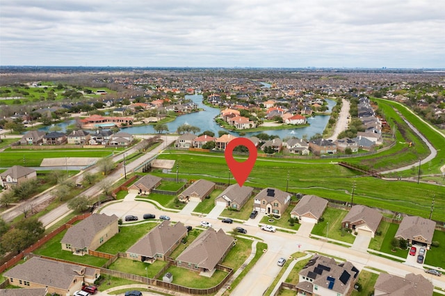 drone / aerial view featuring a residential view and a water view