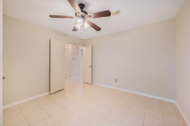 13930 Bonnercrest Dr, Houston, TX 77083 - unfurnished bedroom with a ceiling fan, baseboards, and light tile patterned floors