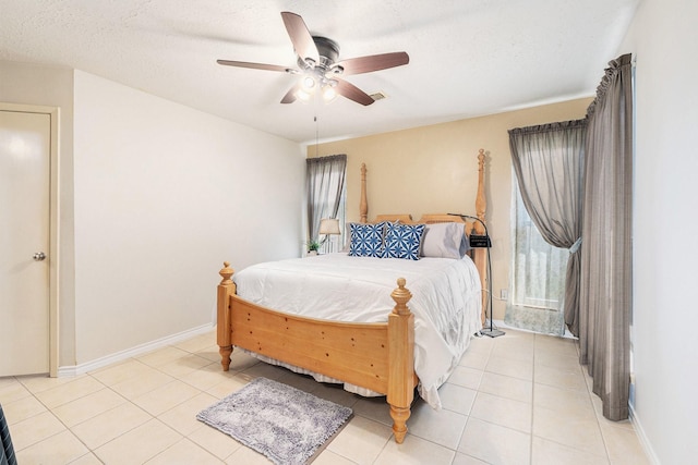 13930 Bonnercrest Dr, Houston, TX 77083 - bedroom with light tile patterned flooring, ceiling fan, baseboards, and a textured ceiling