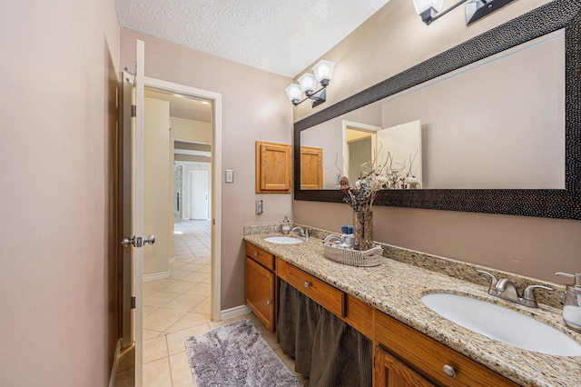 13930 Bonnercrest Dr, Houston, TX 77083 - full bathroom with tile patterned floors, double vanity, baseboards, and a textured ceiling
