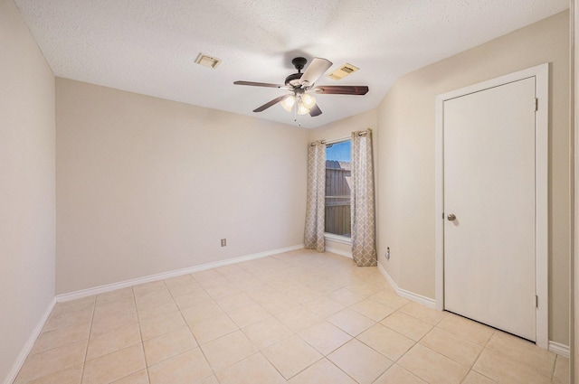 13930 Bonnercrest Dr, Houston, TX 77083 - unfurnished bedroom with a ceiling fan, baseboards, a textured ceiling, and light tile patterned floors