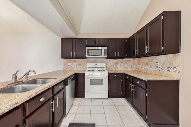 13930 Bonnercrest Dr, Houston, TX 77083 - kitchen featuring appliances with stainless steel finishes, a sink, light tile patterned floors, decorative backsplash, and vaulted ceiling