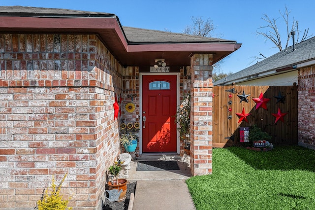 13930 Bonnercrest Dr, Houston, TX 77083 - view of exterior entry featuring a shingled roof and brick siding