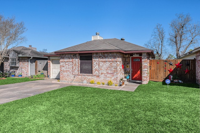 view of front of property with fence, concrete driveway, a front lawn, a garage, and brick siding