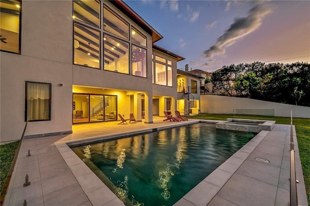 view of swimming pool featuring stairs, a patio, fence, and a pool with connected hot tub