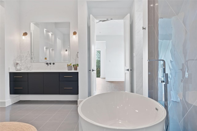 full bathroom featuring a freestanding bath, tile patterned floors, a stall shower, and vanity