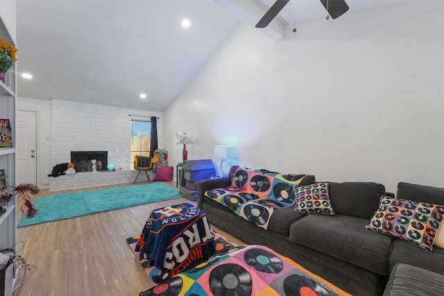 living area with beamed ceiling, a ceiling fan, wood finished floors, recessed lighting, and a fireplace