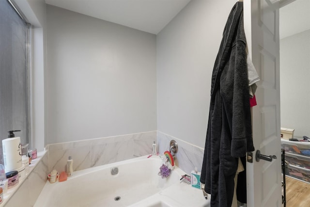 bathroom featuring a bath and wood finished floors