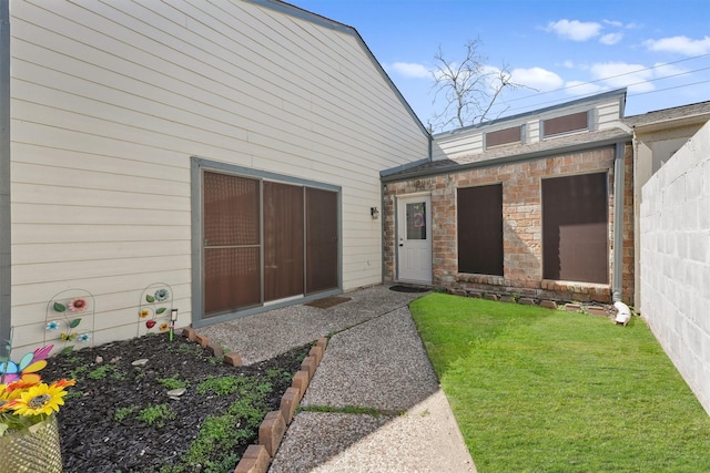 doorway to property with a lawn