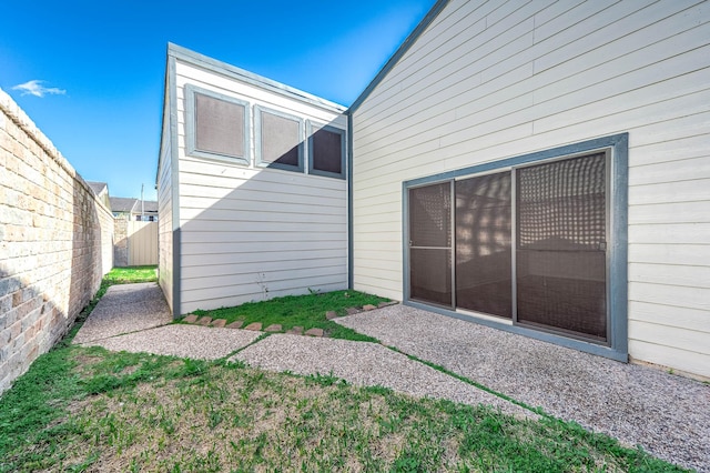 back of house with fence