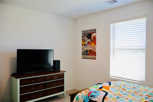 carpeted bedroom with baseboards and visible vents